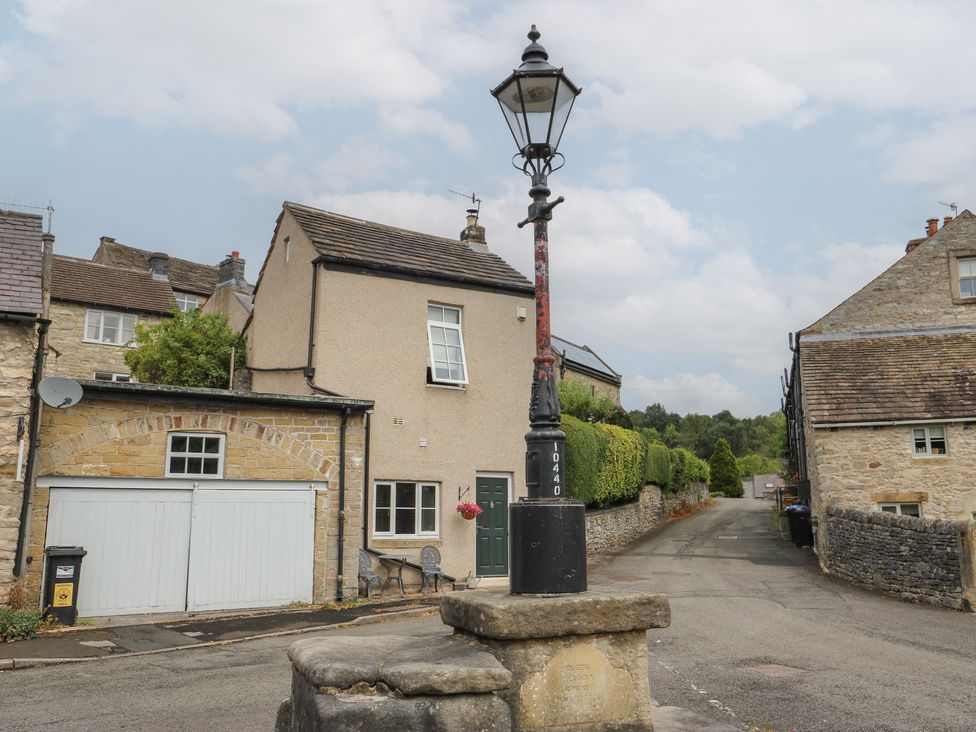 A street view with a lamp post and houses at Laneside Barn in Calver