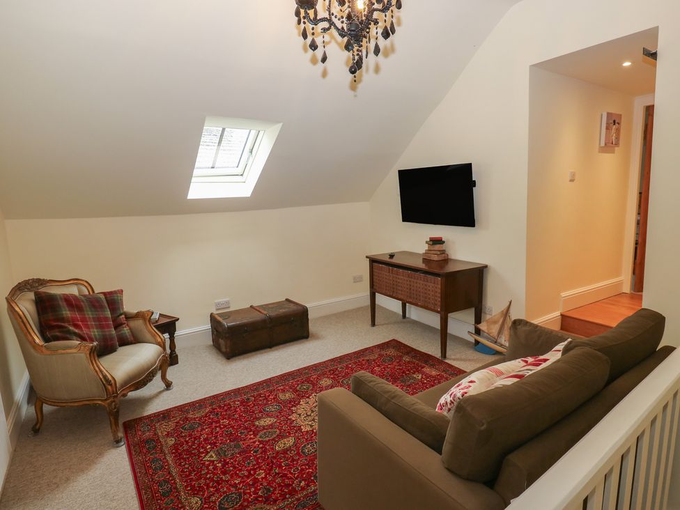 A snug with seating and a television at Laneside Barn Calver