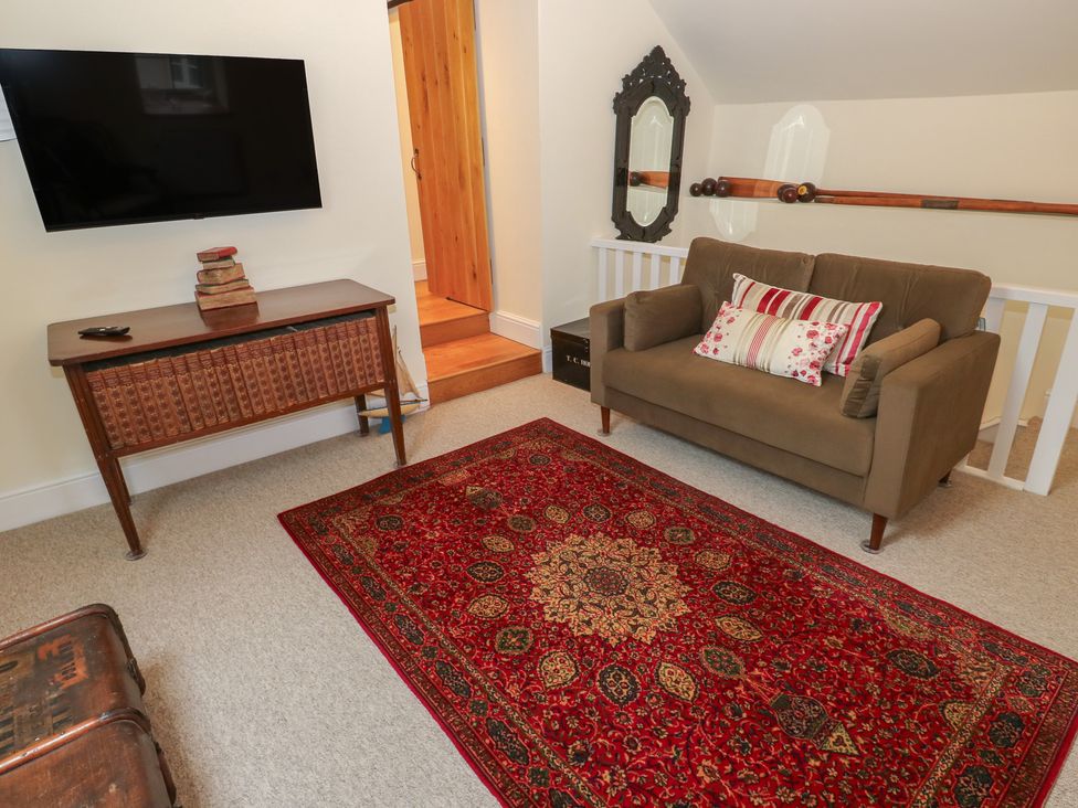 A living room with a sofa and television at Laneside Barn Calver