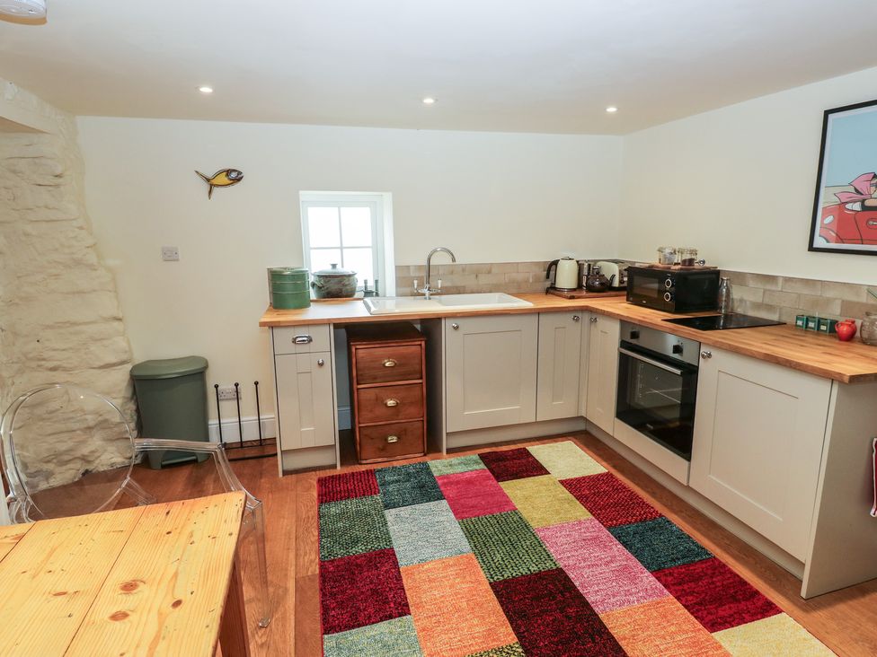 A kitchen with cabinets and sink at Laneside Barn in Calver