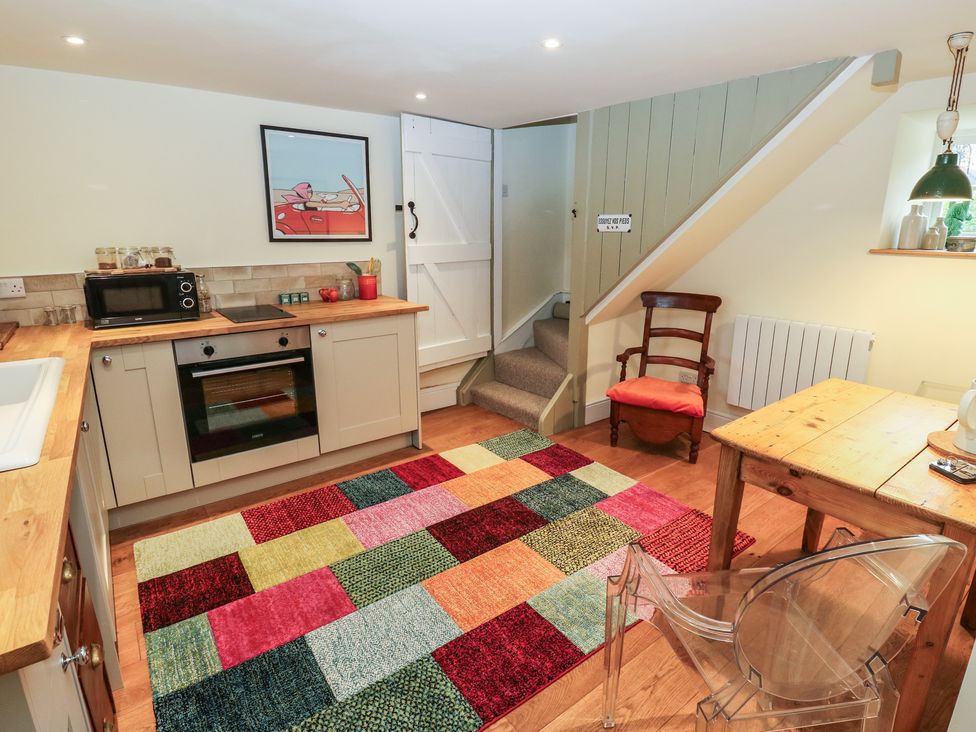 A kitchen with appliances and seating at Laneside Barn in Calver