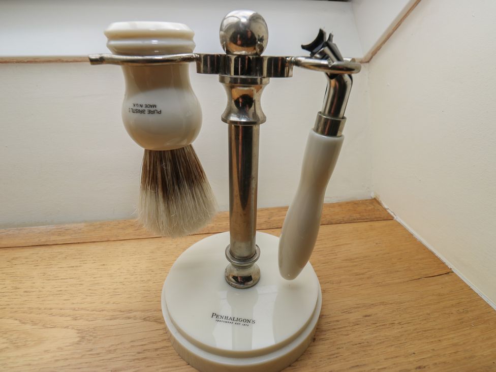 A shaving brush and razor on a stand at Laneside Barn Calver