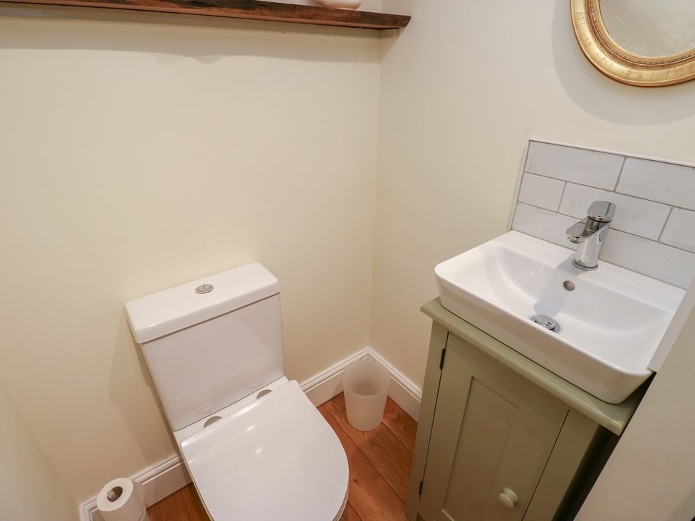 A bathroom with a toilet and sink at Laneside Barn in Calver