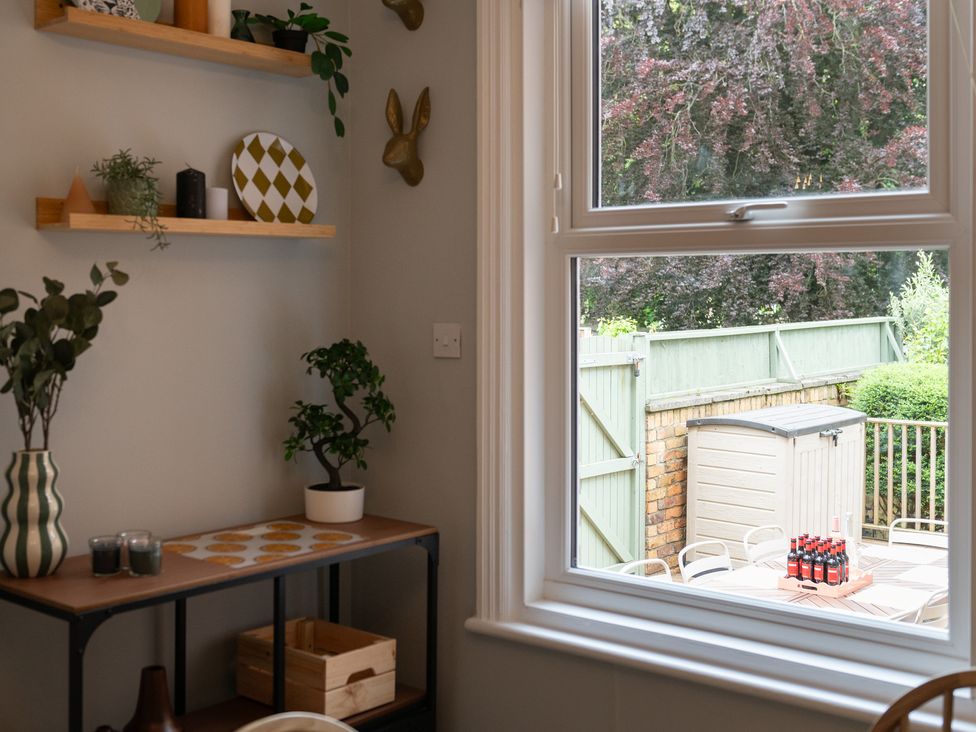 A kitchen with shelves and a view of a garden at 59 Garfield Road, Scarborough
