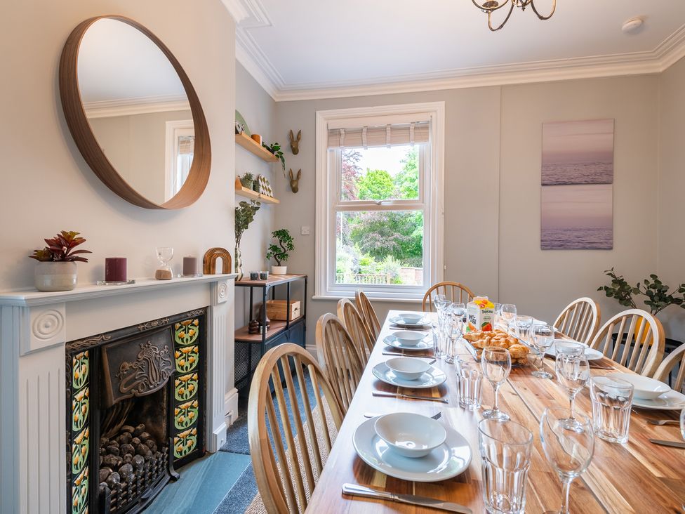 A dining room with a table set for a meal at 59 Garfield Road Scarborough