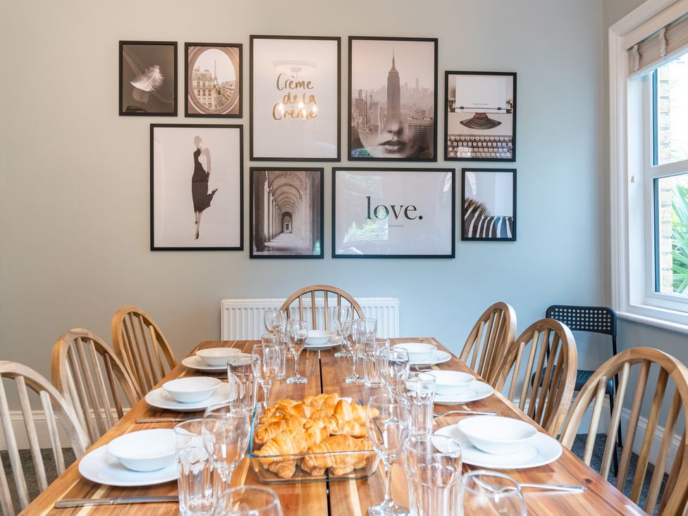 A dining room with a wooden table set for a meal at 59 Garfield Road in Scarborough