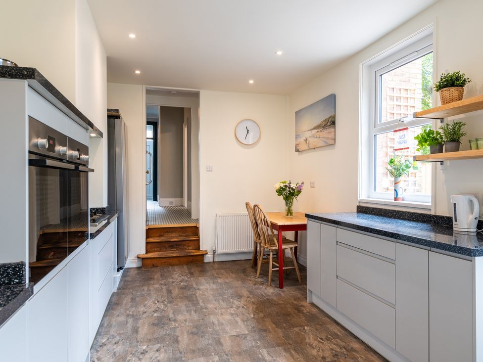 A kitchen with a dining table and chairs at 59 Garfield Road, Scarborough