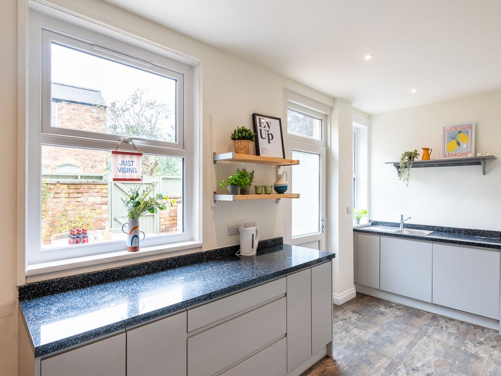 A kitchen with large windows and a countertop with plants at 59 Garfield Road in Scarborough