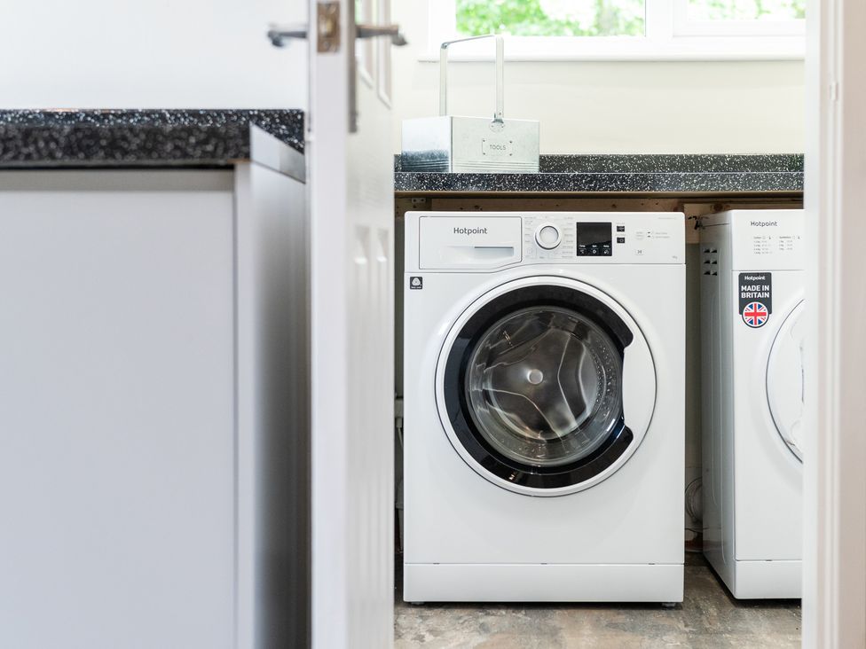 A laundry room with washing machines and a worktop at 59 Garfield Road, Scarborough