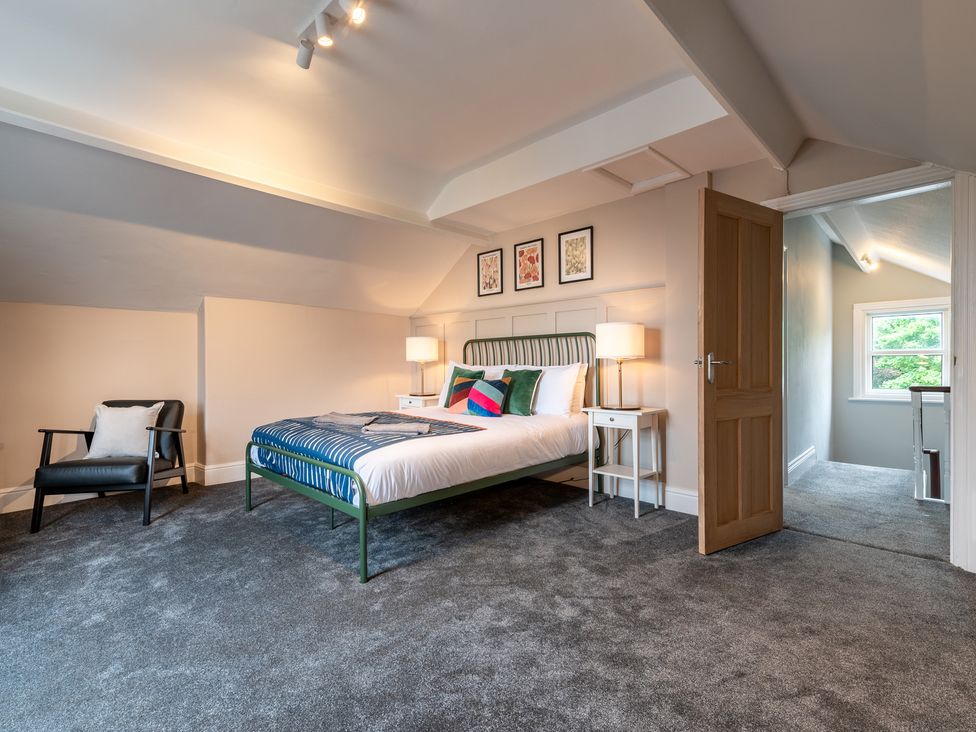 A bedroom with a bed and side tables at 59 Garfield Road Scarborough