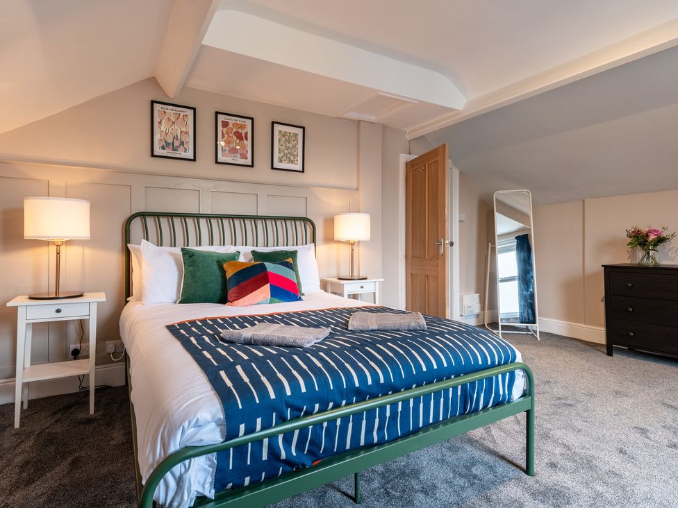 A bedroom with a bed and two nightstands at 59 Garfield Road Scarborough