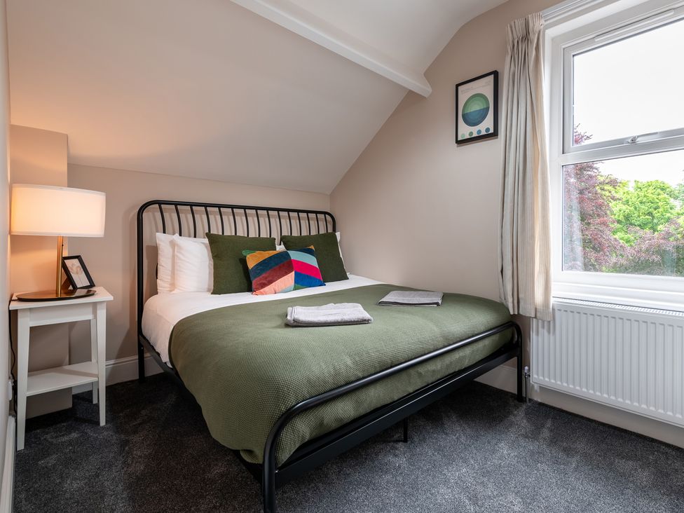 A bedroom with a bed and bedside table at 59 Garfield Road, Scarborough