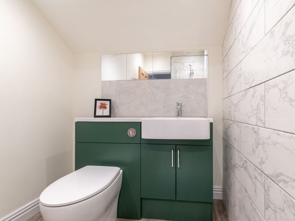 A bathroom with a toilet and sink at 59 Garfield Road Scarborough