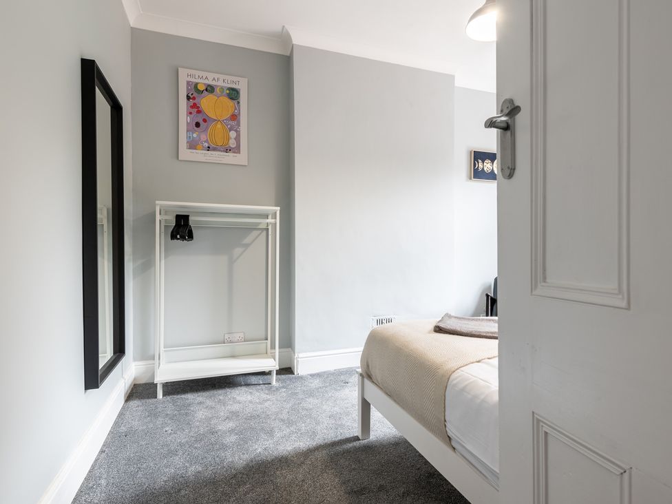 A bedroom with a bed and mirror at 59 Garfield Road in Scarborough