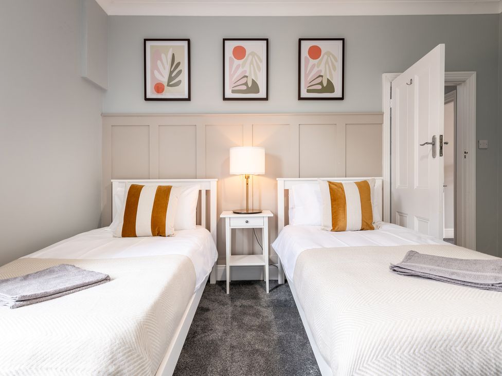 A bedroom with two beds and wall art at 59 Garfield Road Scarborough