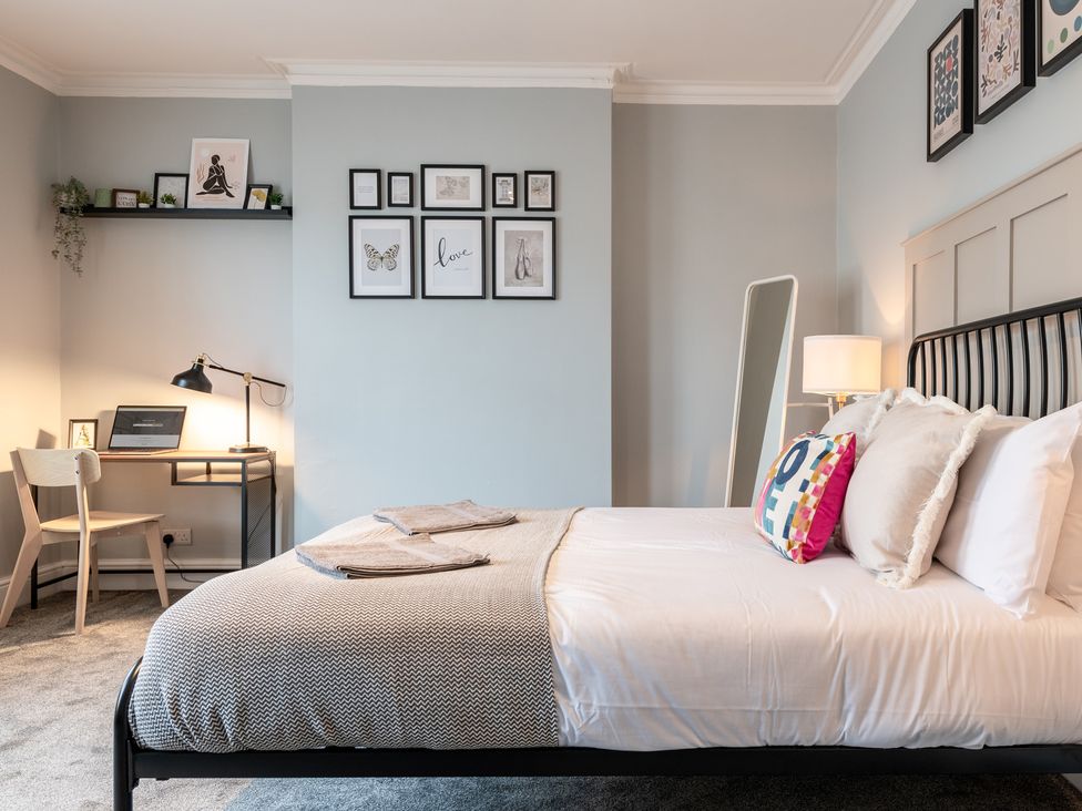 A bedroom with a bed and a desk at 59 Garfield Road, Scarborough