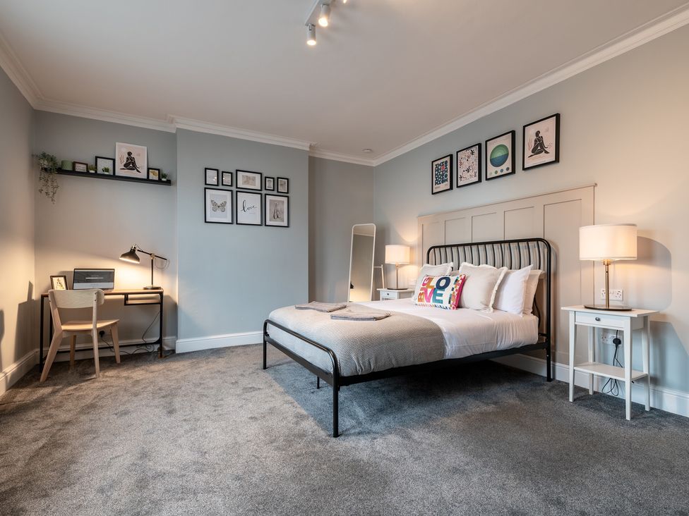A bedroom with a bed and desk at 59 Garfield Road Scarborough