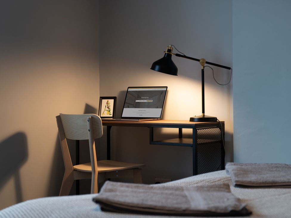 An office space with a desk, chair, lamp, and laptop at 59 Garfield Road, Scarborough