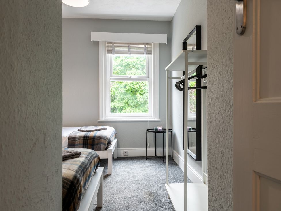 A bedroom with two beds and a mirror at 59 Garfield Road in Scarborough