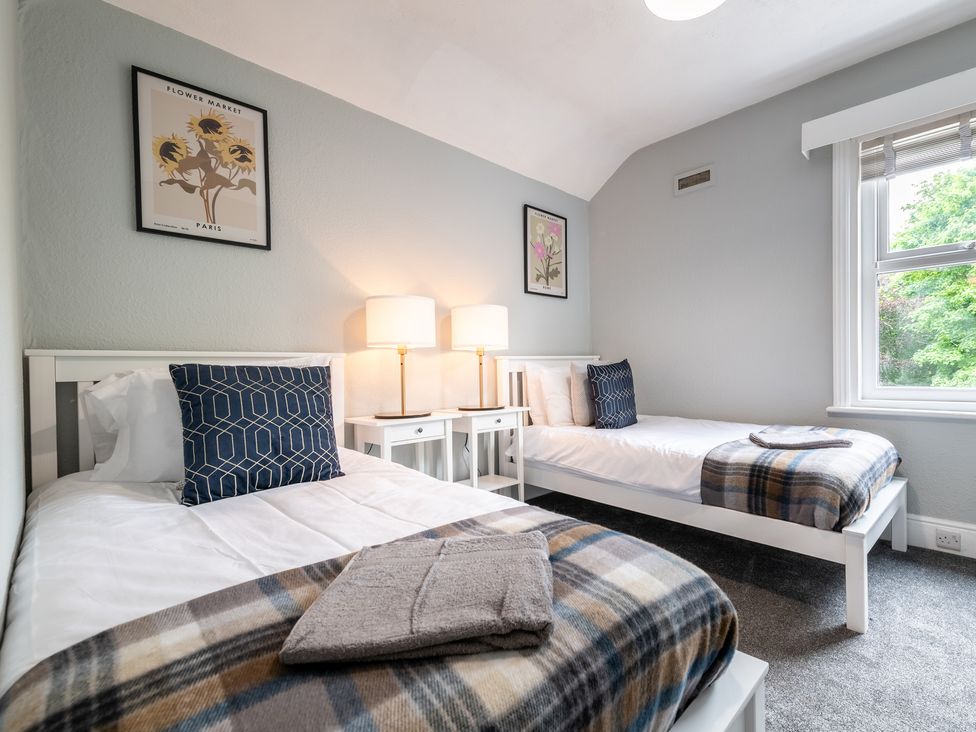 A bedroom with two beds and a window at 59 Garfield Road in Scarborough