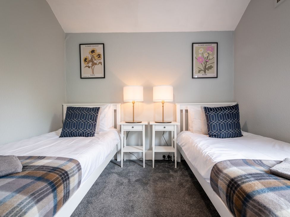 A bedroom with two single beds and nightstands at 59 Garfield Road, Scarborough