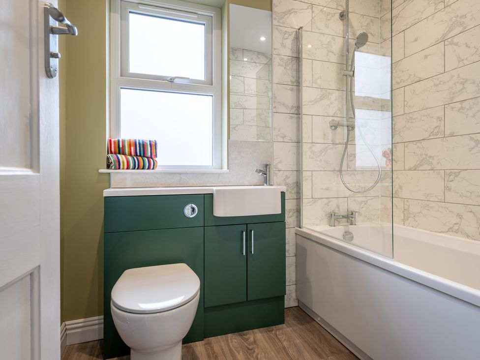 A bathroom with a sink, toilet, and bathtub at 59 Garfield Road in Scarborough