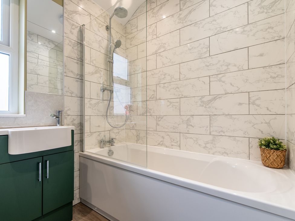 A bathroom with a bath tub and shower at 59 Garfield Road in Scarborough