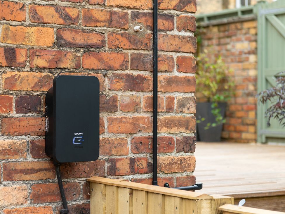 A charging station mounted on a brick wall at 59 Garfield Road, Scarborough