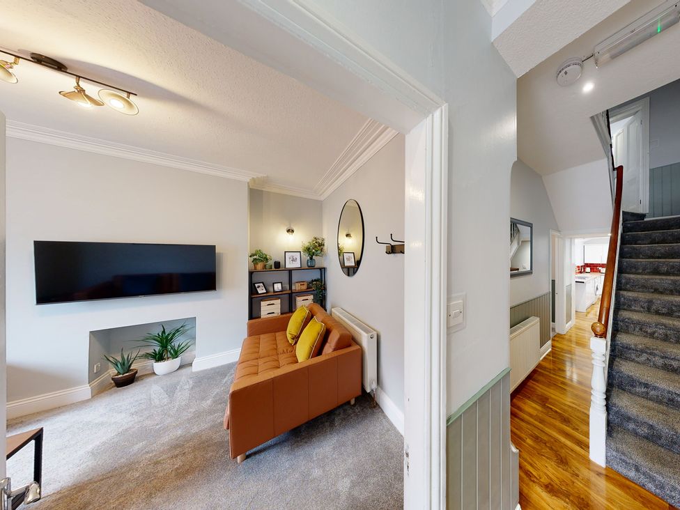 A living room with a television and sofa at 44 Norwood Street, Scarborough