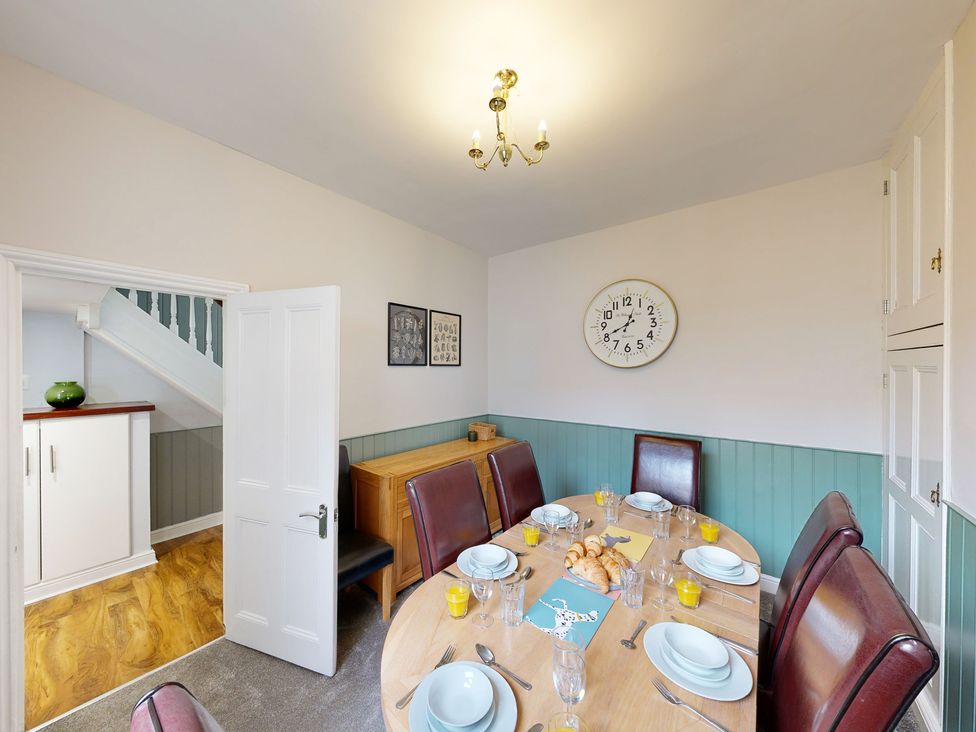 A dining room with a table set for meals at 44 Norwood Street Scarborough