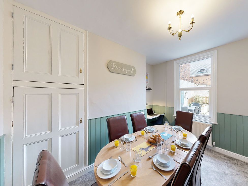 A dining room with a table set for meal at 44 Norwood Street Scarborough