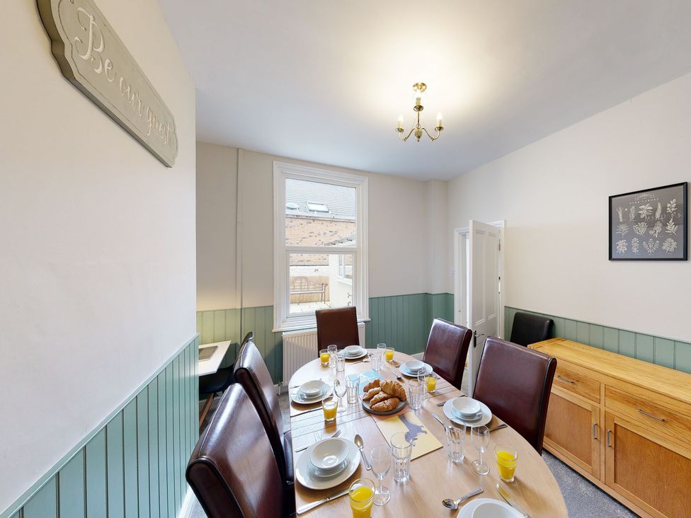 A dining room with a table set for meals at 44 Norwood Street Scarborough