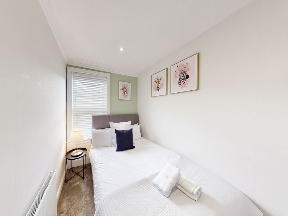 A bedroom with a bed and wall art at 44 Norwood Street Scarborough