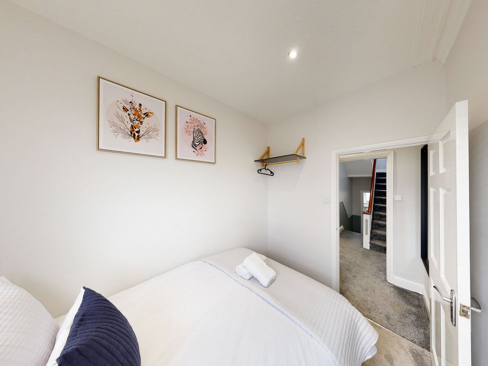 A bedroom with a bed and wall art at 44 Norwood Street Scarborough