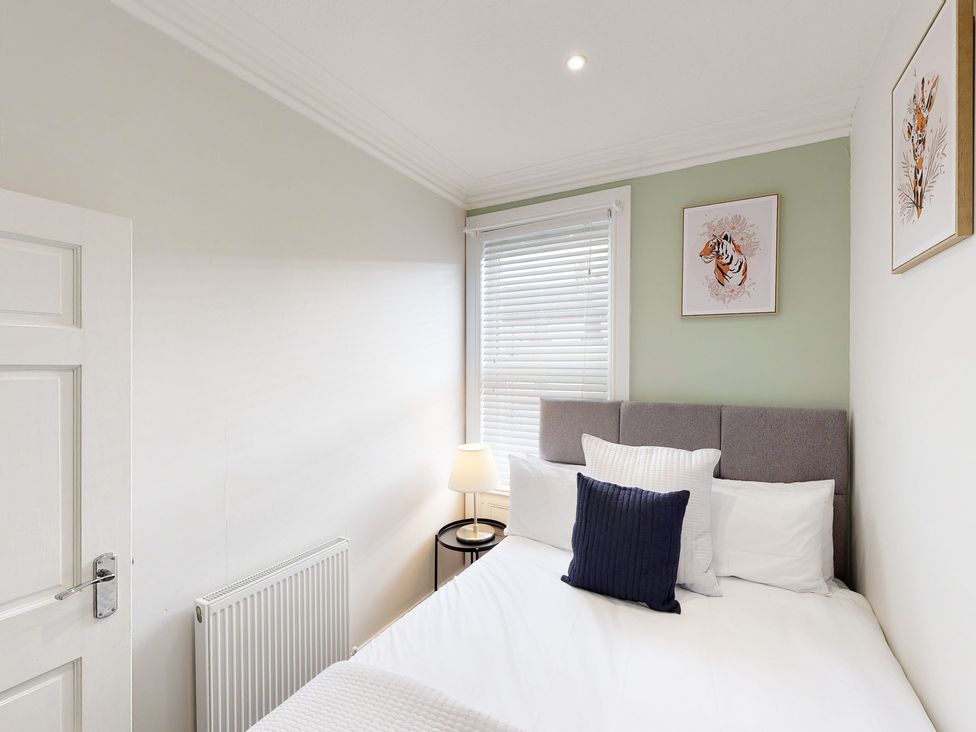 A bedroom with a bed and a lamp at 44 Norwood Street Scarborough
