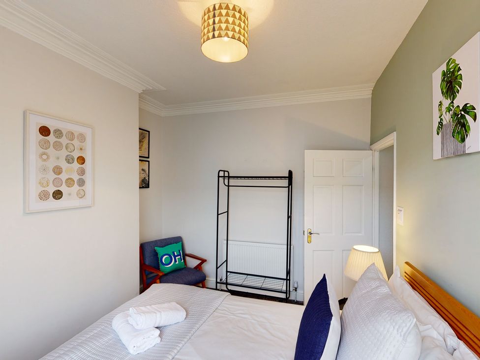 A bedroom with a bed and artwork on the wall at 44 Norwood Street Scarborough
