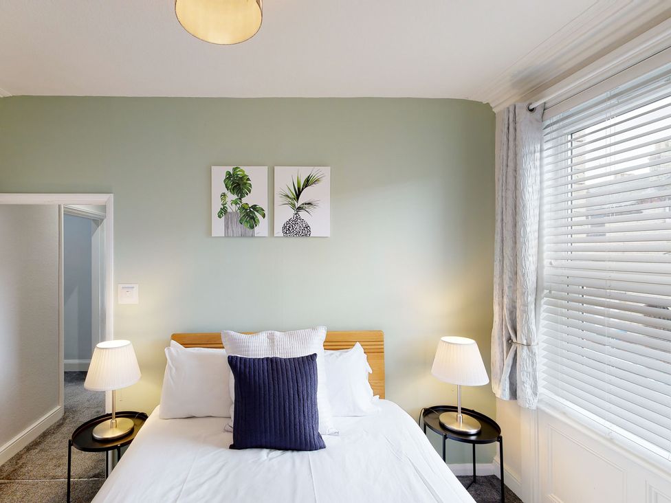 A bedroom with a bed and lamps at 44 Norwood Street Scarborough