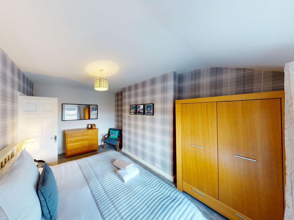 A bedroom with a bed and a dresser at 44 Norwood Street in Scarborough
