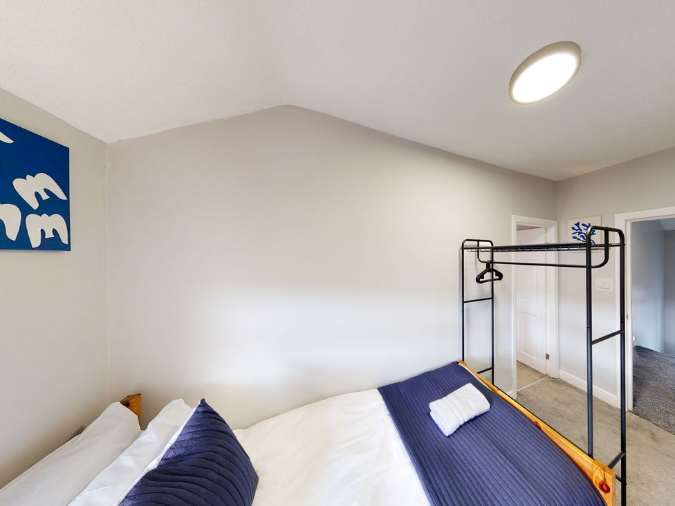 A bedroom with a bed and wall art at 44 Norwood Street Scarborough