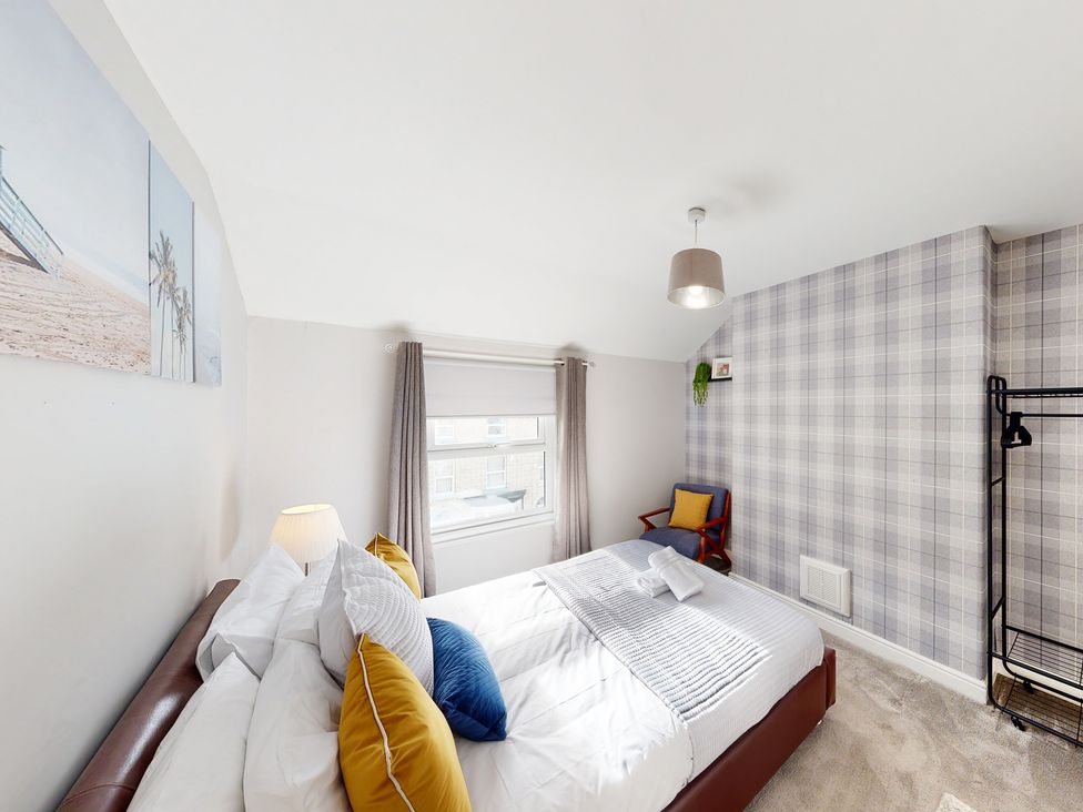 A bedroom with a bed and chair at 44 Norwood Street Scarborough