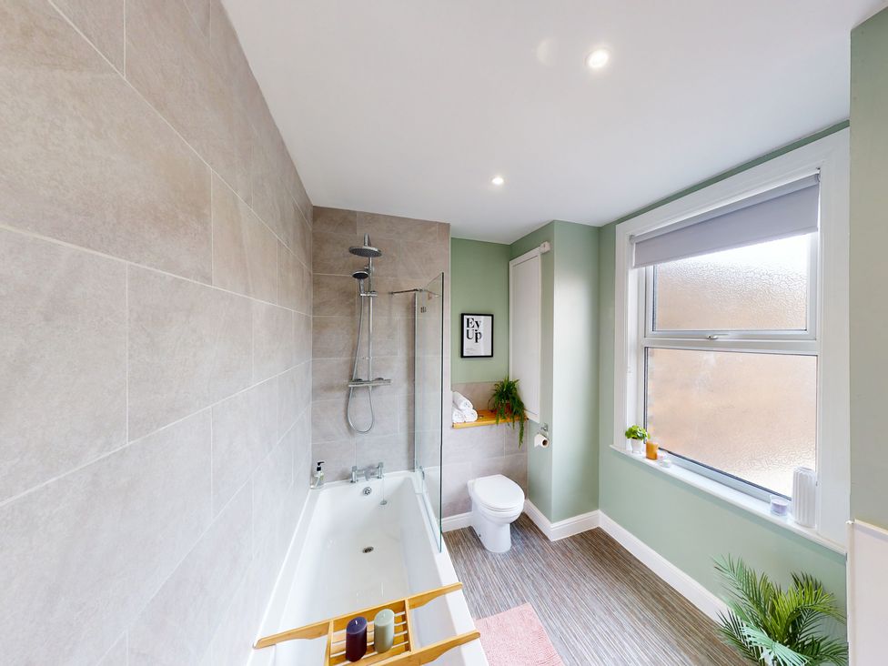 A bathroom with a bathtub and shower at 44 Norwood Street Scarborough