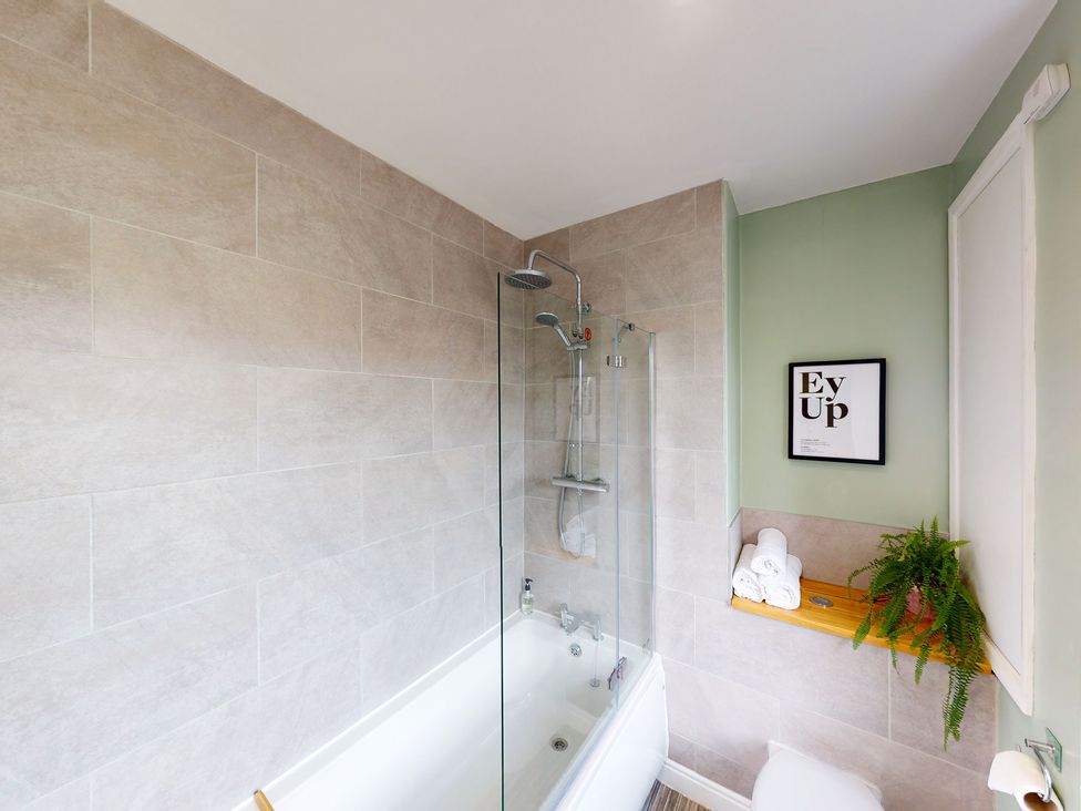 A bathroom with a shower and bathtub at 44 Norwood Street in Scarborough