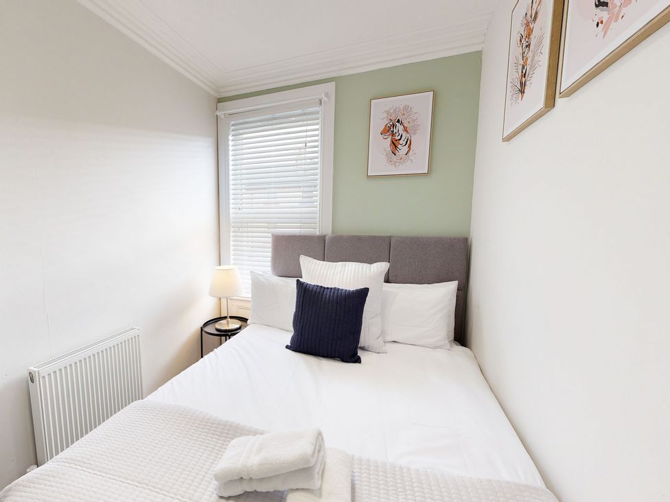 A bedroom with a bed and lamp at 44 Norwood Street Scarborough