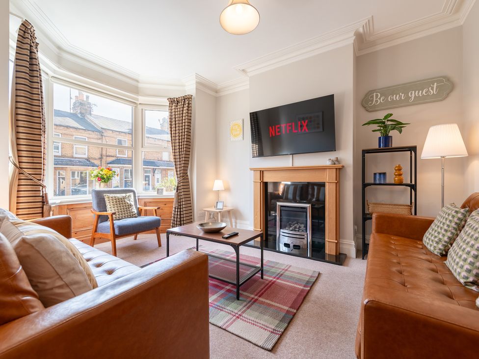 A living room with a sofa and television at 18 Mayville Avenue Scarborough