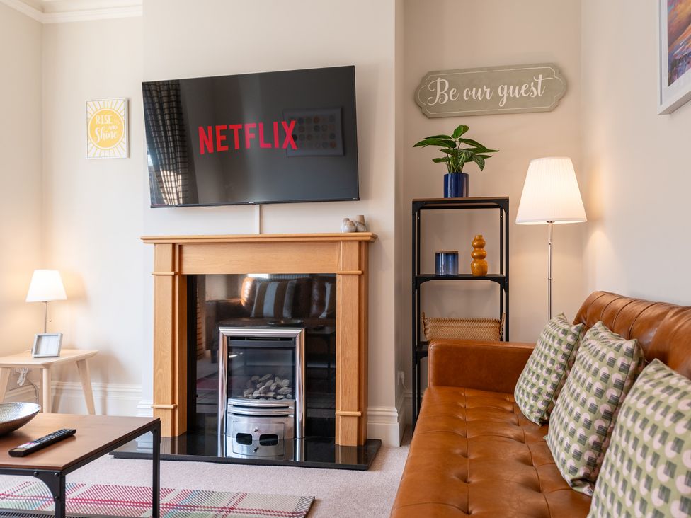 A living room with a television and fireplace at 18 Mayville Avenue, Scarborough