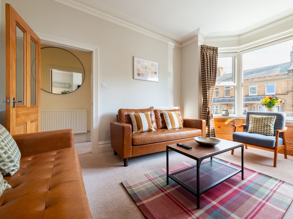 A living room with a sofa and coffee table at 18 Mayville Avenue in Scarborough