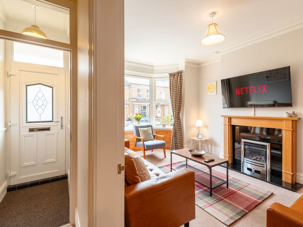 A living room with a sofa and TV at 18 Mayville Avenue in Scarborough