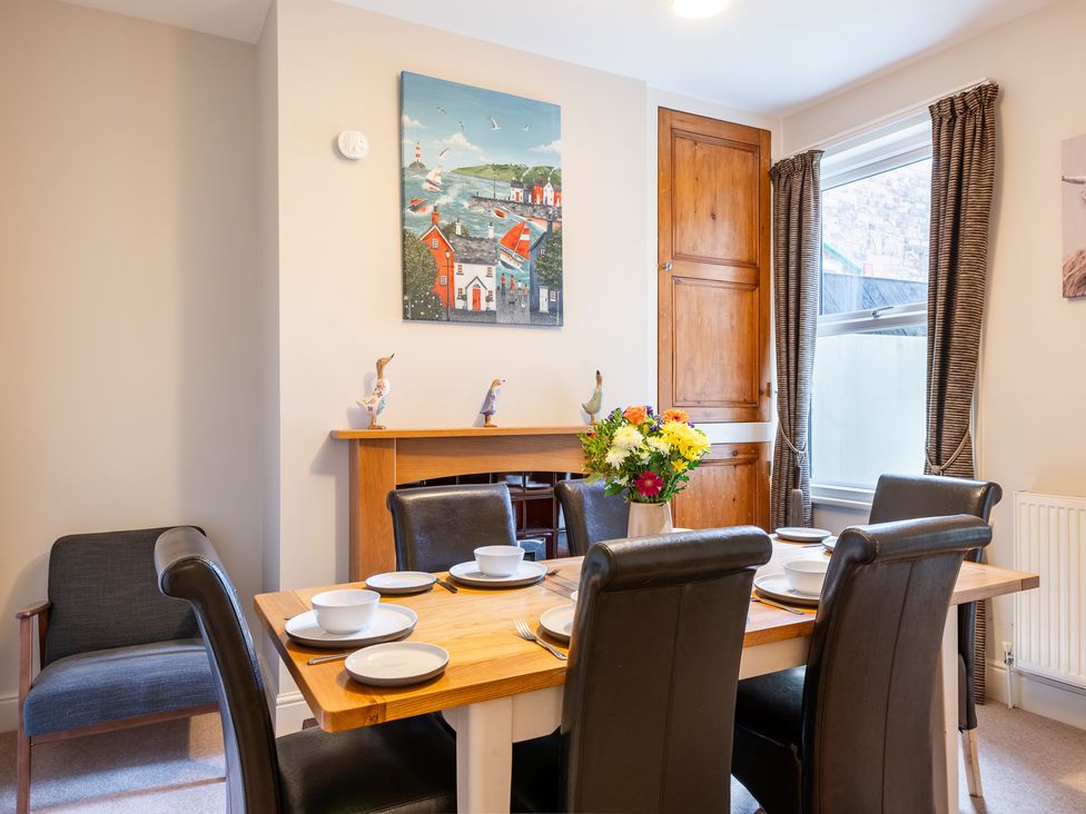 A dining room with a table set for a meal at 18 Mayville Avenue Scarborough