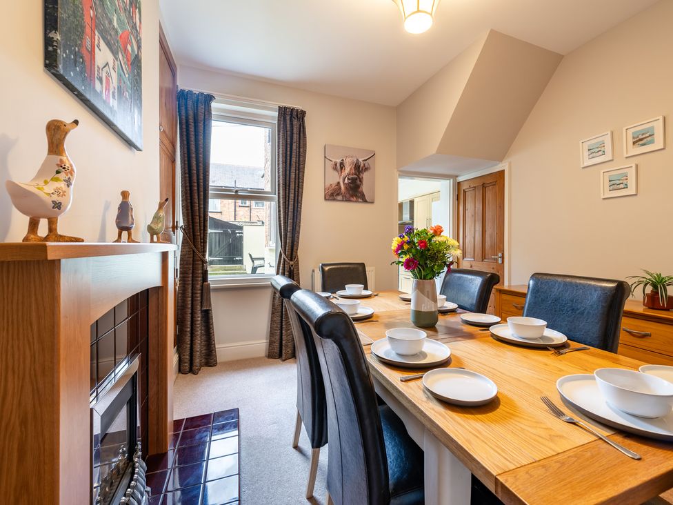 A dining room with a table set for meals at 18 Mayville Avenue in Scarborough