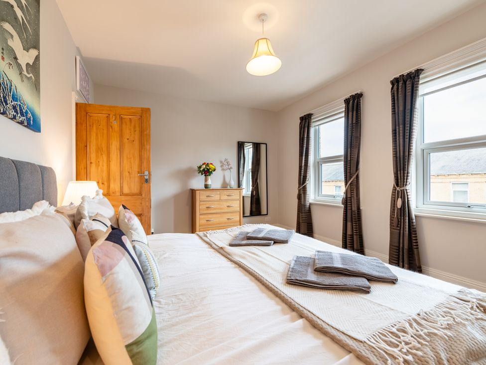 A bedroom with a bed and decorative pillows at 18 Mayville Avenue in Scarborough